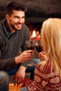 Winter holidays and people concept - romantic couple drink wine