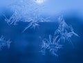 Winter Holidays Season Fantasy World Concept: Macro Image of Natural Ice Crystals Patterns on a Blue Frosted Window Pane With Sun Royalty Free Stock Photo