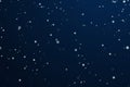 Winter holidays and wintertime background, white snow falling on dark blue backdrop, snowflakes bokeh and snowfall Royalty Free Stock Photo