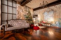 Winter home decor. Christmas in loft interior against brick wall. gifts under the tree. star lamp with light bulbs Royalty Free Stock Photo