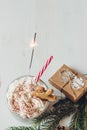 Winter hot drink with gingerbread men cookie, sparkler and christmas decoration on the wooden white table Royalty Free Stock Photo