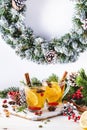 Winter hot tea with cranberry, lemon and spices in glass cup in Christmas or New Year`s table setting, white background Royalty Free Stock Photo