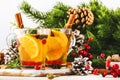 Winter hot tea with cranberry, lemon and spices in glass cup in Christmas or New Year`s table setting, white background Royalty Free Stock Photo