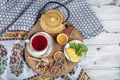 Winter hot tea with fruit, berries and spices in a cup on a table seen with cast iron teapot and herbs and dried fruits Royalty Free Stock Photo