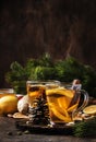 Winter hot tea with fruit, lemon and spices in glass cup with steam in Christmas or New Year`s table setting, rustic wooden Royalty Free Stock Photo