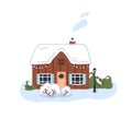 Winter house with snow on roof. Cozy wooden home in nature, smoke from chimney. Rural wood building in snowy cold