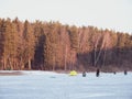 Winter ice fishing, lake, forest, frosty day. fishermans Royalty Free Stock Photo