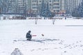 Winter ice fishing, lake, frosty day. Fisherman engaged in ice fishing in the pond of the city Park Royalty Free Stock Photo