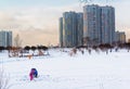 Winter ice fishing, lake, frosty day. Fisherman engaged in ice fishing in the pond of the city Park Royalty Free Stock Photo