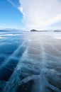 Winter ice landscape on lake Baikal with dramatic weather clouds