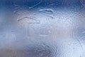Winter ice pattern on the frozen window. Texture, background for inserting text. New Year theme. Winter. Cold. Royalty Free Stock Photo