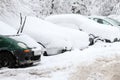 Winter. Ice. Snow. People walks a snowy icy road passing snowy cars on uncleaned icy street after a heavy snowfall. Unclea Royalty Free Stock Photo