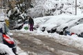 Winter. Ice. Snow. People walks a snowy icy road passing snowy cars on uncleaned icy street after a heavy snowfall. Unclea Royalty Free Stock Photo