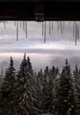 Winter icicles on a window frame with a mountain view Royalty Free Stock Photo