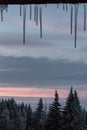 Winter icicles on a window frame with a mountain view Royalty Free Stock Photo