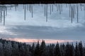 Winter icicles on a window frame with a mountain view Royalty Free Stock Photo