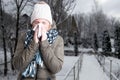 Winter illness concept with woman blowing into napkin Royalty Free Stock Photo