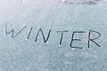 Winter inscription on snow on the front window of car