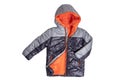 Winter jacket. Close-up of a stylish cosy warm silver black down jacket with orange lining for kids isolated on a white background