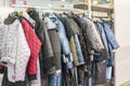 Winter Jacket in Winter Sale on a clothes rack. Women's coats on hangers in a women's clothing store