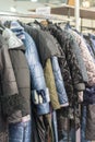 Winter Jacket in Winter Sale on a clothes rack. Women's coats on hangers in a women's clothing store. vertical photo