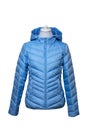 Winter jackets. Close-up of a stylish cosy warm blue down jacket for womans on mannequin isolated on a white. Fashionable women