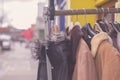 Winter jackets hanging on rail outside