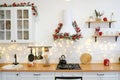 Winter kitchen with red decorations, christmas cooking table and utensils