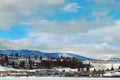 Winter lake, mountains and town Royalty Free Stock Photo