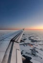 Winter landing. Wing of an airplane with fully extended flaps