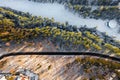 Winter landscape from the air, view of the mountain river and the road passing through the forest. Winter landscape in the Royalty Free Stock Photo