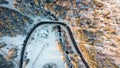 Winter landscape from the air, view of the mountain river and the road passing through the forest. Winter landscape in the Royalty Free Stock Photo