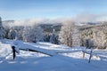 Winter landscape of Beskid Mountains in Poland, forest and mountain glade with wooden fence covered with fresh white snow Royalty Free Stock Photo