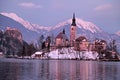 Winter landscape of Bled Lake and island church on sunset