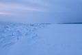 Winter landscape in blue tones with ridged ice on the frozen river Royalty Free Stock Photo