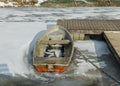 Winter landscape with a boat on the shore of the lake, ice covered lake, Lake Burtnieki Royalty Free Stock Photo