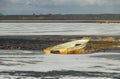 Winter landscape with a boat on the shore of the lake, ice covered lake, Lake Burtnieki Royalty Free Stock Photo