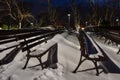 Winter landscape from Burgas Sea Garden, near the Culture center Sea Casino at blue hour, Bulgaria. Benches covered with snow Royalty Free Stock Photo