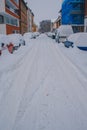 Winter landscape in the city of Braunschweig, Germany. Snow covered street and cars. Winter season with heavy snowfall