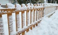 Winter landscape in the city park. A snow-covered fence and a snowdrift after a heavy snowfall Royalty Free Stock Photo