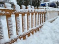 Winter landscape in the city park. A snow-covered fence and a snowdrift after a heavy snowfall Royalty Free Stock Photo