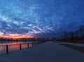 Winter landscape with cloudy sunset over the frozen lake Royalty Free Stock Photo