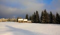 winter landscape with a cottage near pine trees covered with snow