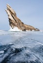 Winter landscape, cracked frozen lake with beautiful mountain island on frozen lake Baikal in Siberia, Russia Royalty Free Stock Photo