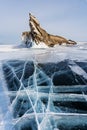 Winter landscape, cracked ground of frozen lake Baikal with beautiful mountain island on frozen lake Royalty Free Stock Photo