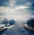 Winter Landscape with Dirty Road and Moody Sky Royalty Free Stock Photo