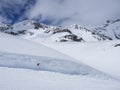 Winter landscape with empty red piste sign, snow covered mountain slopes, spring sunny day at ski resort Stubai