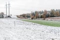 Winter landscape with first snow in the countryside fields with late autumn colors