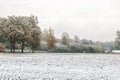 Winter landscape with first snow in the countryside fields with late autumn colors