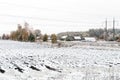 Winter landscape with first snow in the countryside fields with late autumn colors